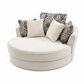 Canapé rond en tissu beige avec coussins décoratifs